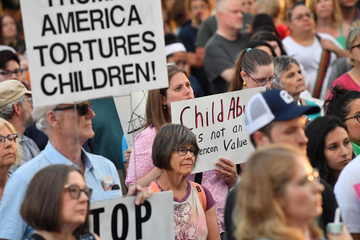 Protesters gather during a "Lights for Liberty" vigil on Friday, July 12, 2019, at Riverfront Park in Spokane, Washington. (Tyler Tjomsland / The Spokesman-Review)