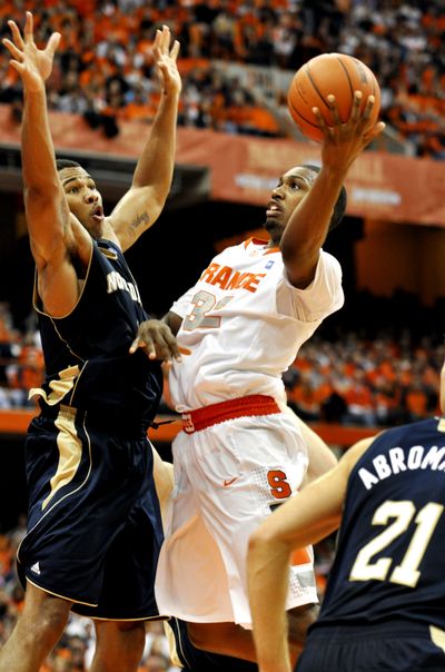 Syracuse’s Kris Joseph shoots in front of Tyrone Nash. (Associated Press)