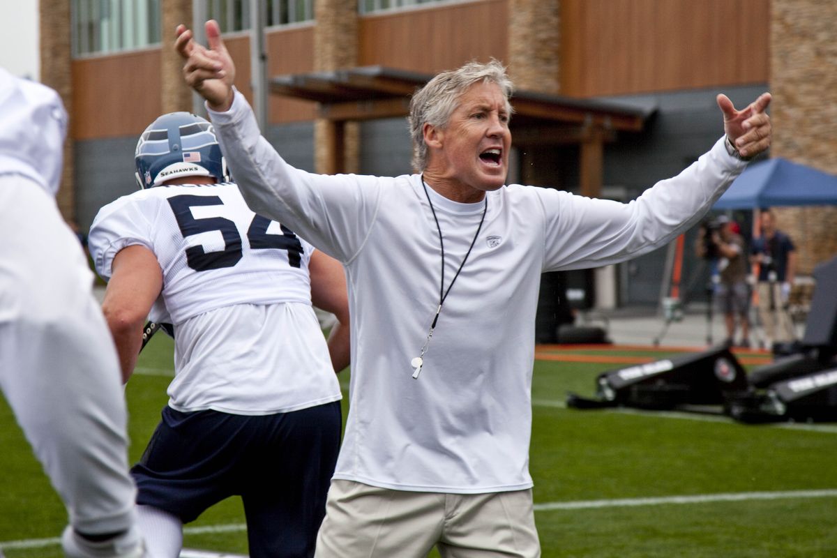 Seahawks coach Pete Carroll urges on the crowd as well as his players during the opening day of training camp. (Associated Press)