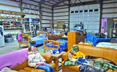 
Autumn, 11, and Hunter Phillips, 6, watch television in their parents' 1,500-square-foot garage while their new home is under construction. 
 (Photos by Brian Plonka/ / The Spokesman-Review)