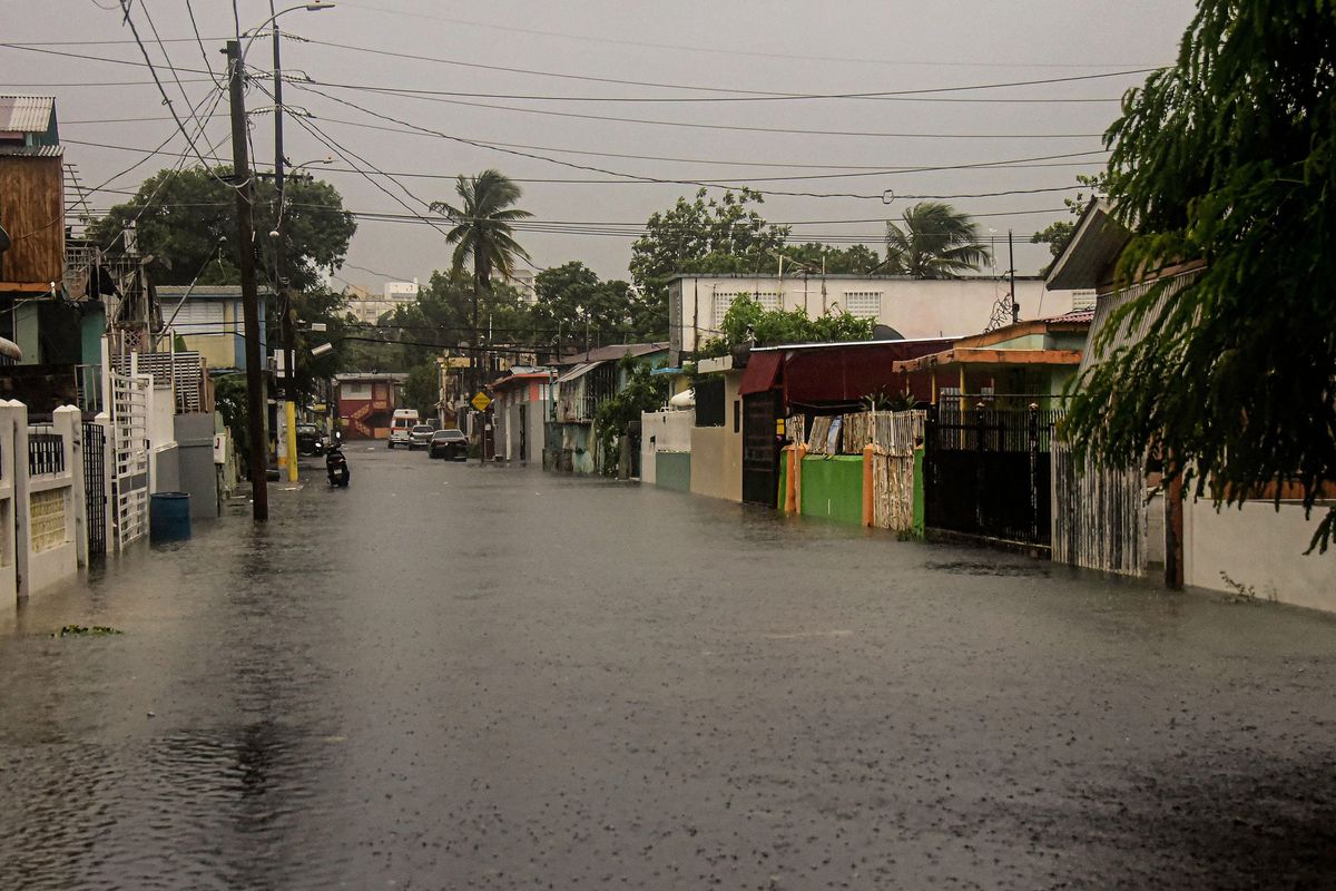 A flooded road is seen during the passage of hurricane Fiona in Villa Blanca, Puerto Rico, on Sunday. Fiona touched Puerto Rico at 3:20 p.m. local time Monday, according to information from the United States National Hurricane Center, leaving a general blackout and rivers overflowing.  (JOSE RODRIGUEZ/Getty Images North America/TNS)