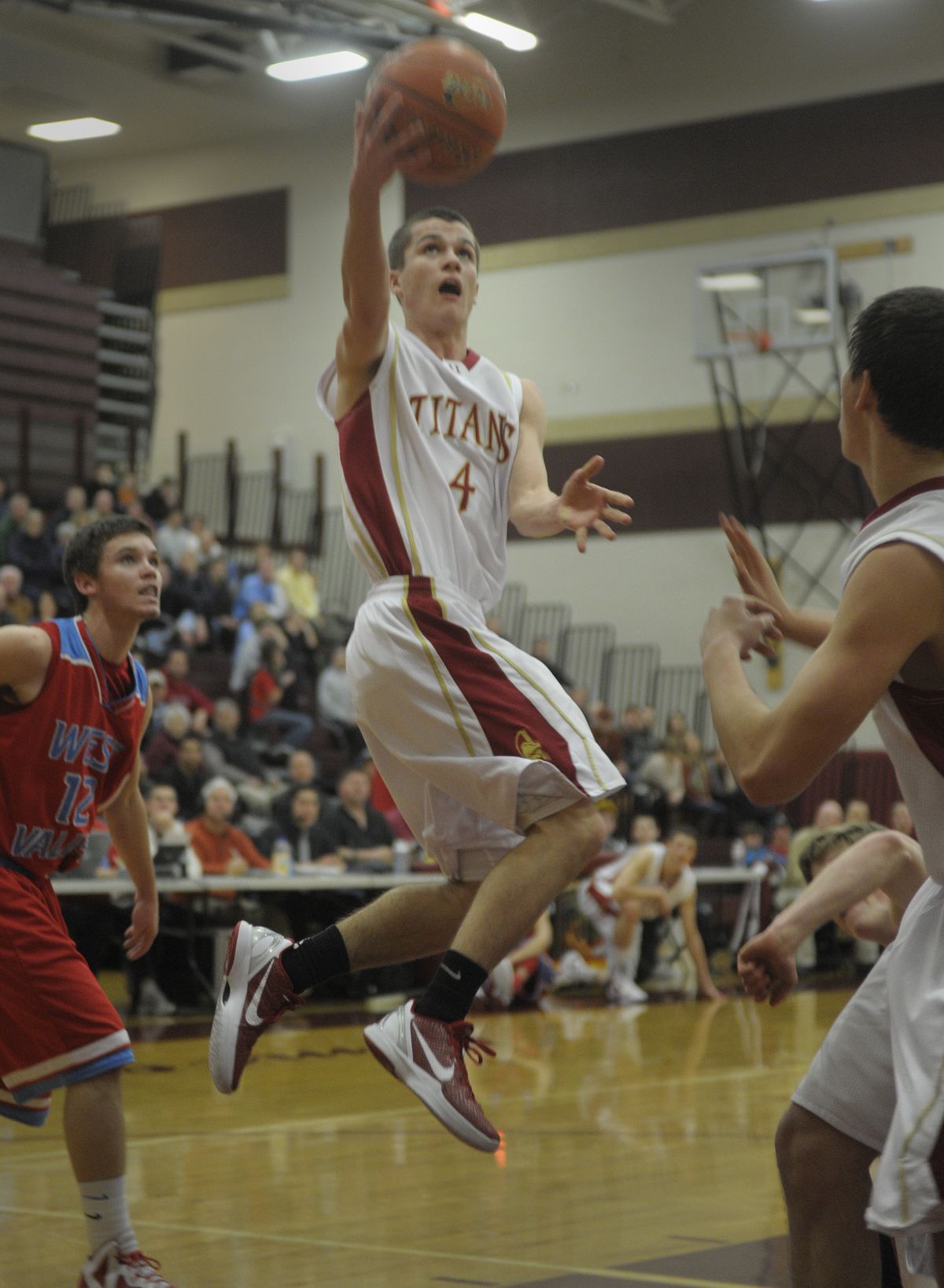 University’s Jared Miller finishes his drive to the basket with a layup. (Christopher Anderson)