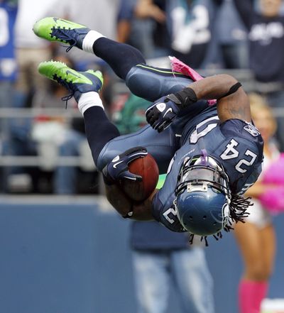 Seahawks running back Marshawn Lynch launches himself into the end zone in the second half. (Associated Press)