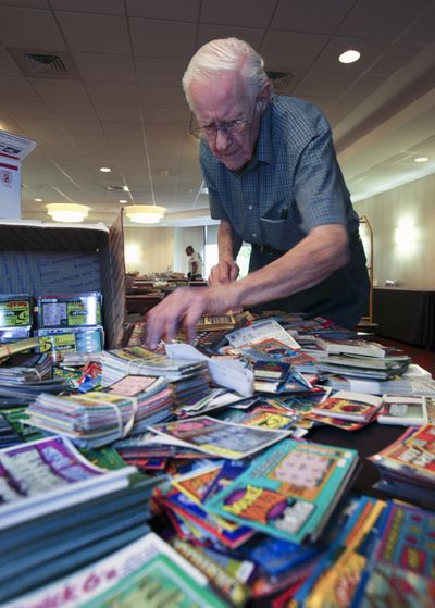 Dale Clauser, from Allentown, Pa., sorts through old lottery tickets during the “Lottovention” in northeast Philadelphia on Friday. (Associated Press)