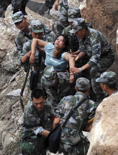 Rescuers save an injured woman after an earthquake hit southwest China’s Sichuan province on Saturday. (Associated Press)