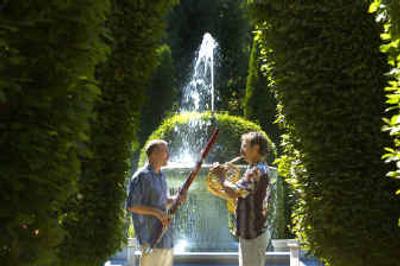
William Berry, left, and Verne Windham warm up by the Davenport Fountain in Manito Park's Duncan Gardens for next week's Mozart at Manito concerts. 
 (Christopher Anderson/ / The Spokesman-Review)