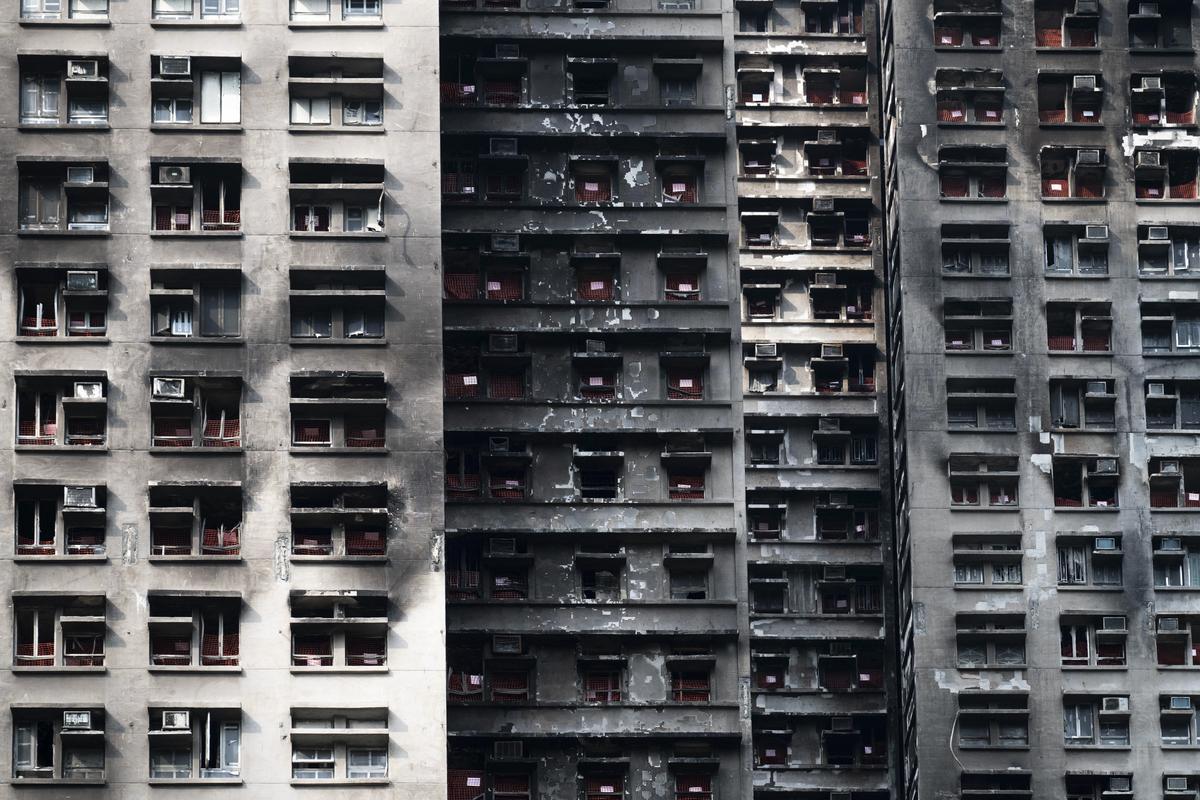 Burned apartments from the November blaze at Wang Fuk Court in the Tai Po district of Hong Kong, April 29, 2026. Evidence shared at hearings show how disabled alarms, flammable materials and ignored warnings contributed to the deaths of 168 people in the complex. (Billy H.C. Kwok/The New York Times)