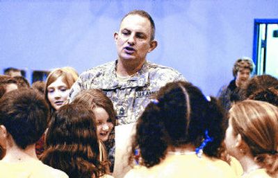 
Students gather around Army Master Sgt. Eric Kramer during a special assembly Wednesday to welcome the second-grade teacher back to Sunrise Elementary School after he served a year in Afghanistan. 
 (J. BART RAYNIAK / The Spokesman-Review)