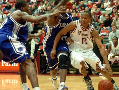 
Washington State's lone senior, Randy Green, here driving past two Kansas State defenders in a victory earlier this month, has picked up more minutes than anticipated. 
 (Associated Press / The Spokesman-Review)