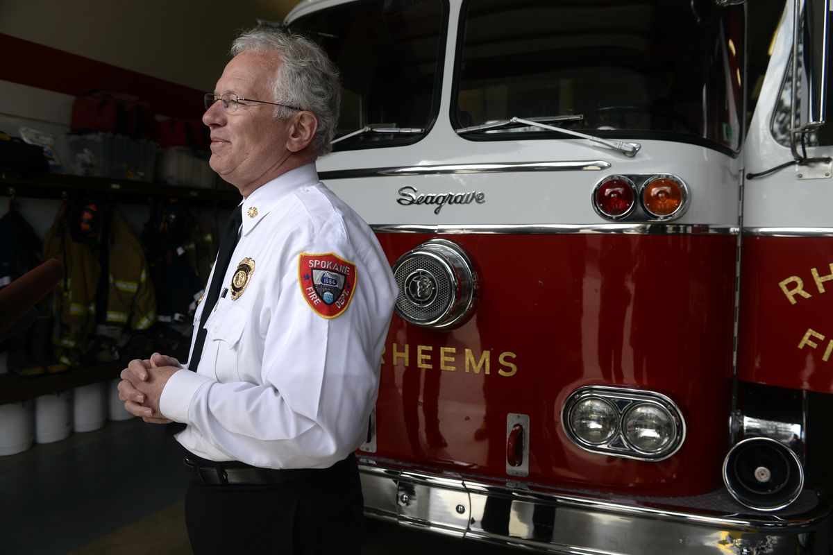Spokane Fire Chief Bobby Williams talks to the media Monday about the 1965 Seagrave firetruck he once used to help his Fire Explorers learn about the fire service on the South Hill. (Jesse Tinsley)