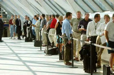 
A long line waits at the Minneapolis-St. Paul International Airport, where frequent business fliers waited their turns Monday to sign up for a 90-day project that allows them to trade personal privacy for travel efficiency. 
 (Associated Press / The Spokesman-Review)