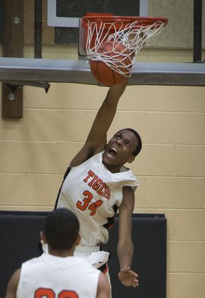 Lewis and Clark's Naje' Smith (34) dunks the ball in the first half of a boy's high school basketball game, Friday, Jan. 23, 2015, at Lewis and Clark High School. (Colin Mulvany / The Spokesman-Review)