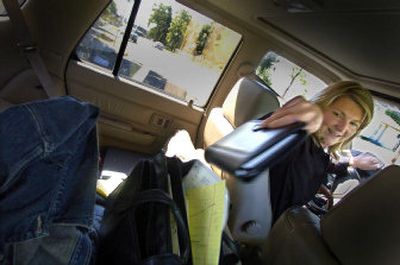 
Lidgerwood Elementary School Principal Valorie Chadwick reaches for some information in her mobile office at Bemiss Elementary while on her way to another school looking for her staff and students Thursday. 
 (Christopher Anderson/ / The Spokesman-Review)