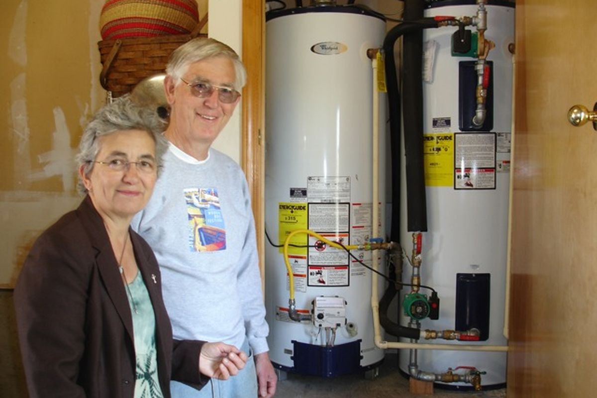 Anne and her husband, Dr. Rolf Nesse, show off the simple installation of the heat system in their garage. (Jean Arthur)