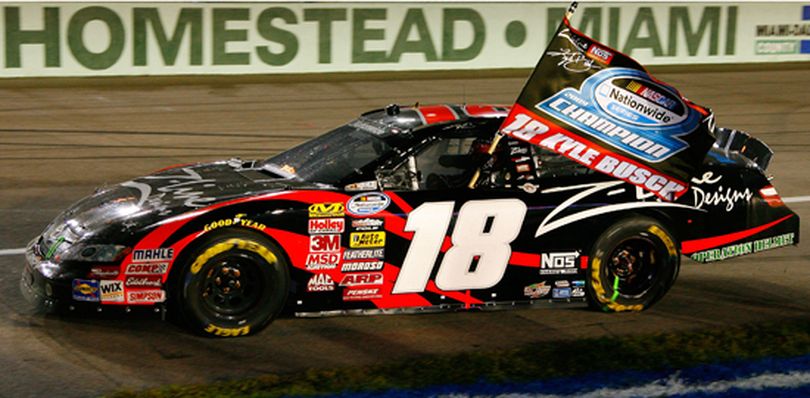 After receiving the checkered flag for winning Saturday's NASCAR Nationwide Ford 300, Kyle Busch, driver of the No. 18 Z-Line Designs Toyota, celebrates by driving the championship flag in the car around Homestead-Miami Speedway in Homestead, Fla. This is Kyle's ninth win of the 2009 season -- but his first at Homestead-Miami Speedway and his first NASCAR national series championship. (Photo by Jason Smith/Getty Images for NASCAR) (Jason Smith / Getty Images North America)