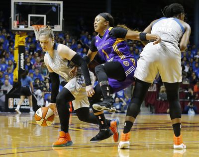 Los Angeles Sparks’ Odyssey Sims, center, tries to squeeze by Minnesota Lynx’s Sylvia Fowles, right, in pursuit of Lynx’s Lindsay Whalen during the first half of Game 2 in the WNBA basketball finals Tuesday, Sept. 26, 2017, in Minneapolis. (Jim Mone / Associated Press)