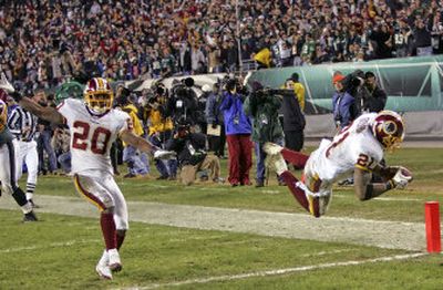 
Redskins safety Sean Taylor soars into the end zone after returning a fumble 39 yards for a game-clinching score.
 (Associated Press / The Spokesman-Review)