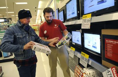 Target employee Andrew Sawatzki helps Eddie Stazel, of Spokane Valley, select a digital TV converter box Wednesday at the Valley store. Stazel used a federal coupon for one box and said he would apply for two more.  (Dan Pelle / The Spokesman-Review)