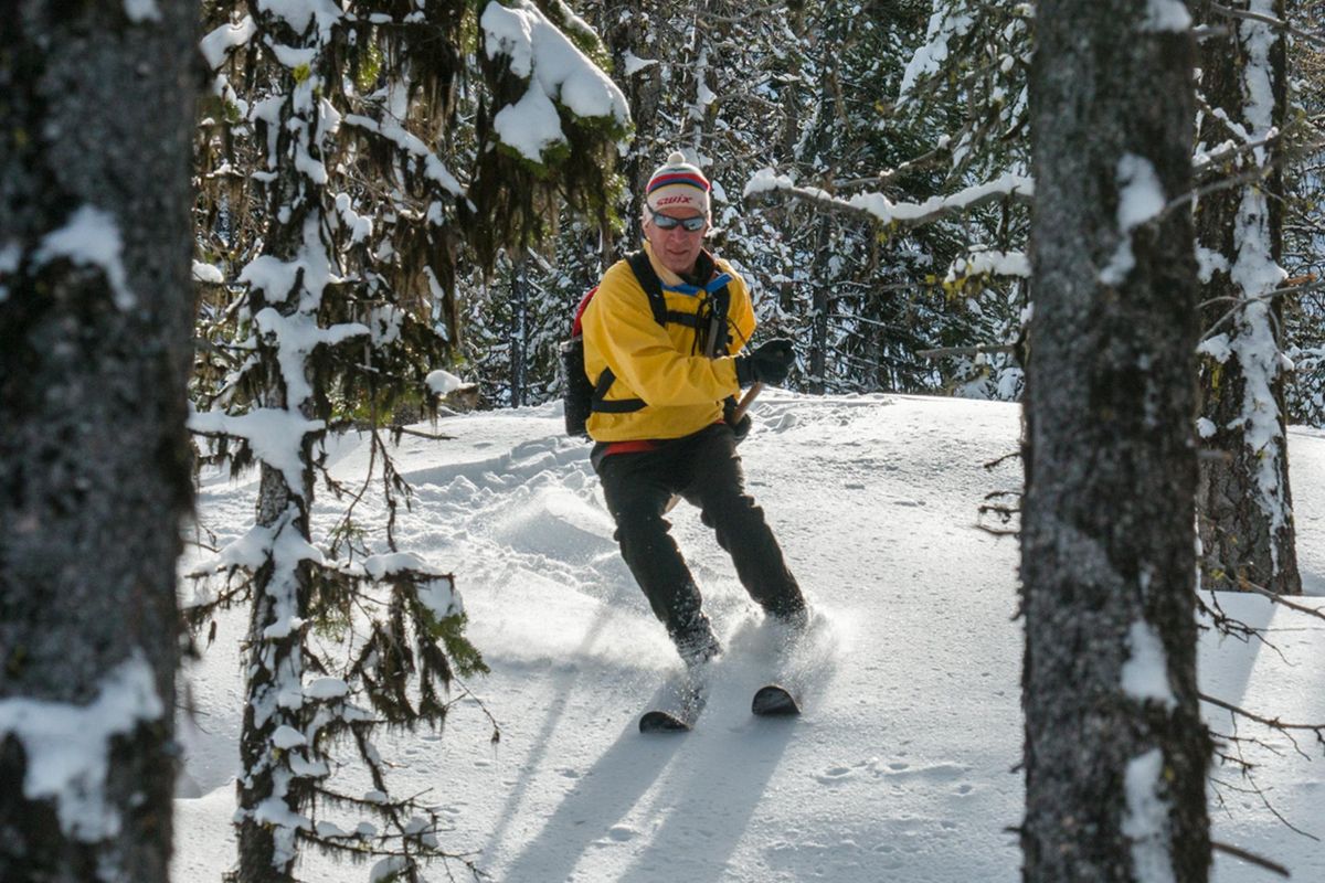 Don Portman, veteran Methow Valley skiing instructor, heads downhill through the woods on Hok skis. (Courtesy)