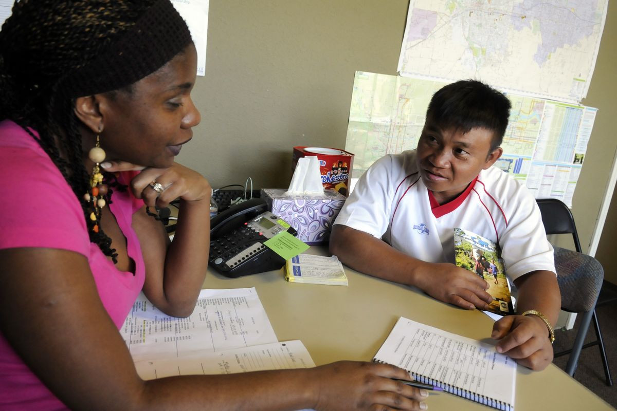 Sony Beck, left, a volunteer case manager, gets help in learning some Karen phrases from Tee Tu,  a refugee from Burma,  on Aug. 17 at Jacob’s Well church in Spokane. The church helps find social services  for refugees after their placement in the Spokane area.  (Jesse Tinsley)