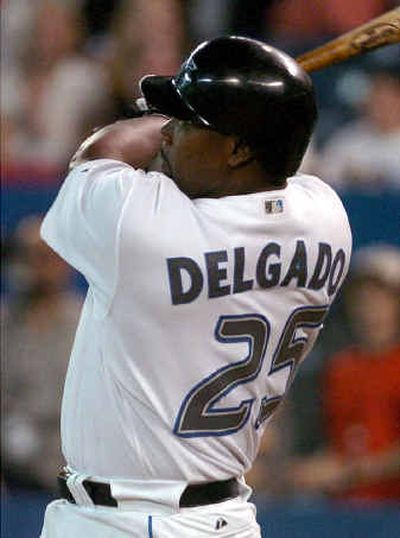 
Toronto's Carlos Delgado, who blew two bases-loaded opportunities earlier, hits a game-winning three-run homer against Seattle in the ninth.
 (Associated Press / The Spokesman-Review)