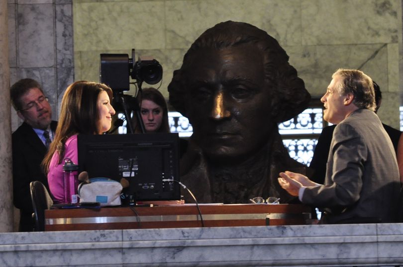 OLYMPIA -- Gov. Jay Inslee talks with TVW's Anita Kissee in the hallway outside the legislative chambers before the session starts Monday. (Jim Camden)