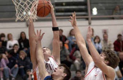 
Kyle Turpin of Post Falls grabs a rebound in heavy traffic in an Inland Empire League showdown with Coeur d'Alene on Saturday. 
 (Tom Davenport / / The Spokesman-Review)