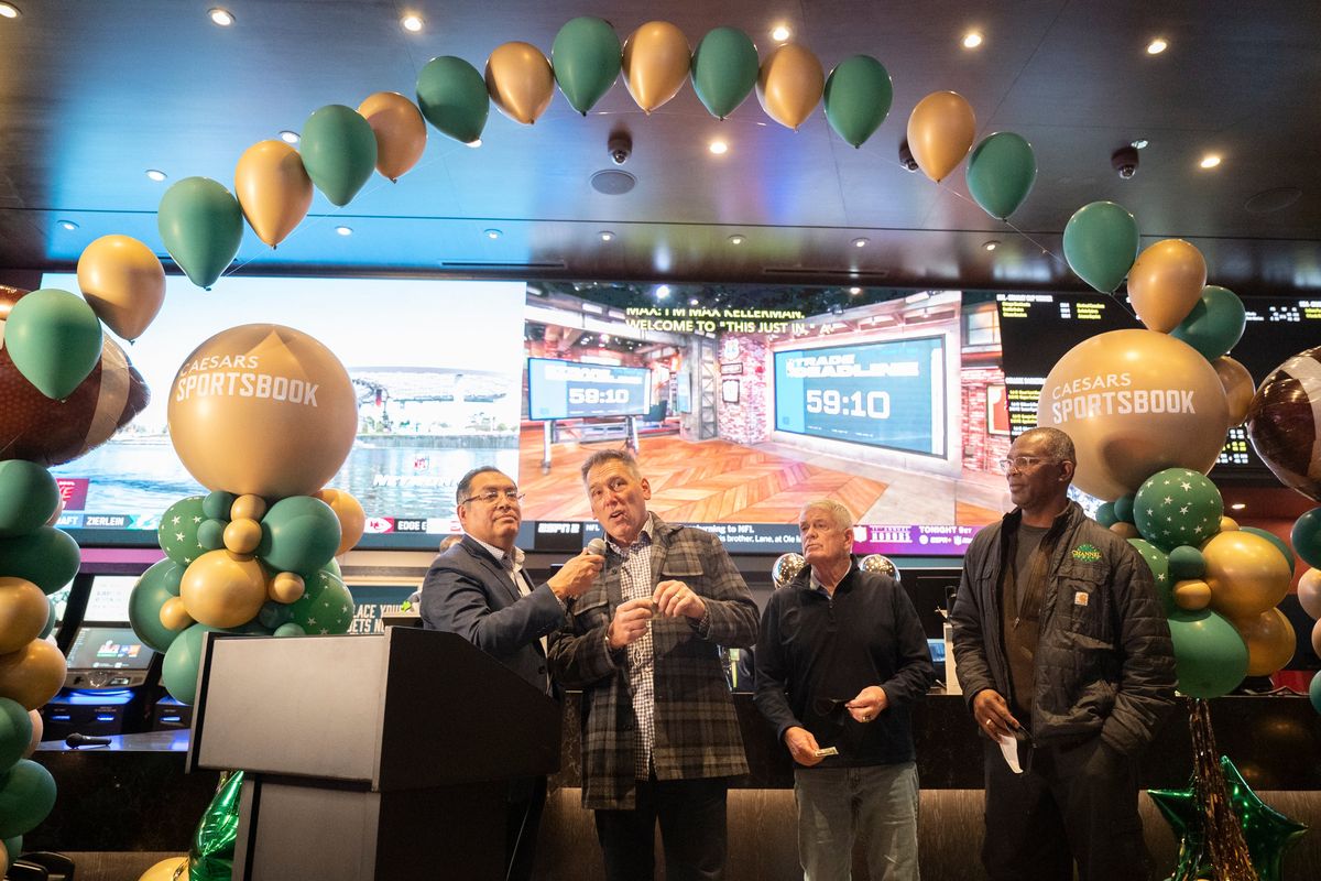 Javier De La Rosa, left, general manager of the Spokane Tribe Casino, interviews former Seahawks quarterback Jim Zorn, along with former NFL and college football coach Dennis Erickson and former NFL player Eric Wright, right, Thursday, Feb. 10, 2022, at the Spokane Tribe Casino in Airway Heights at the opening of the casino