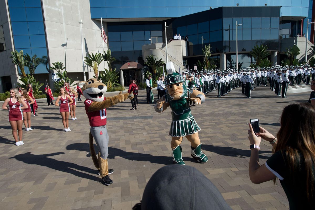 WSU mascot Butch meets Michigan State mascot Sparty during a Holiday Bowl battle of the bands on Wednesday, December 27, 2017, in San Diego, Calif. (Tyler Tjomsland / The Spokesman-Review)