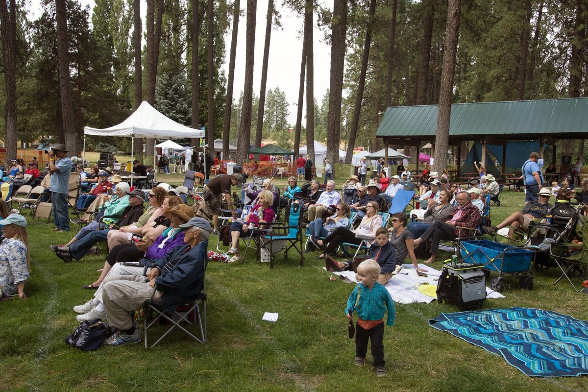 People enjoy the Blue Waters Bluegrass Festival in August of 2017 in Medical Lake. (Colin Mulvany / The Spokesman-Review)