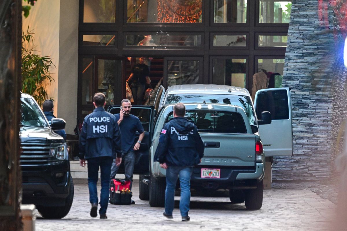 Homeland Security Investigations agents are seen at the entrance of Sean "Diddy" Combs