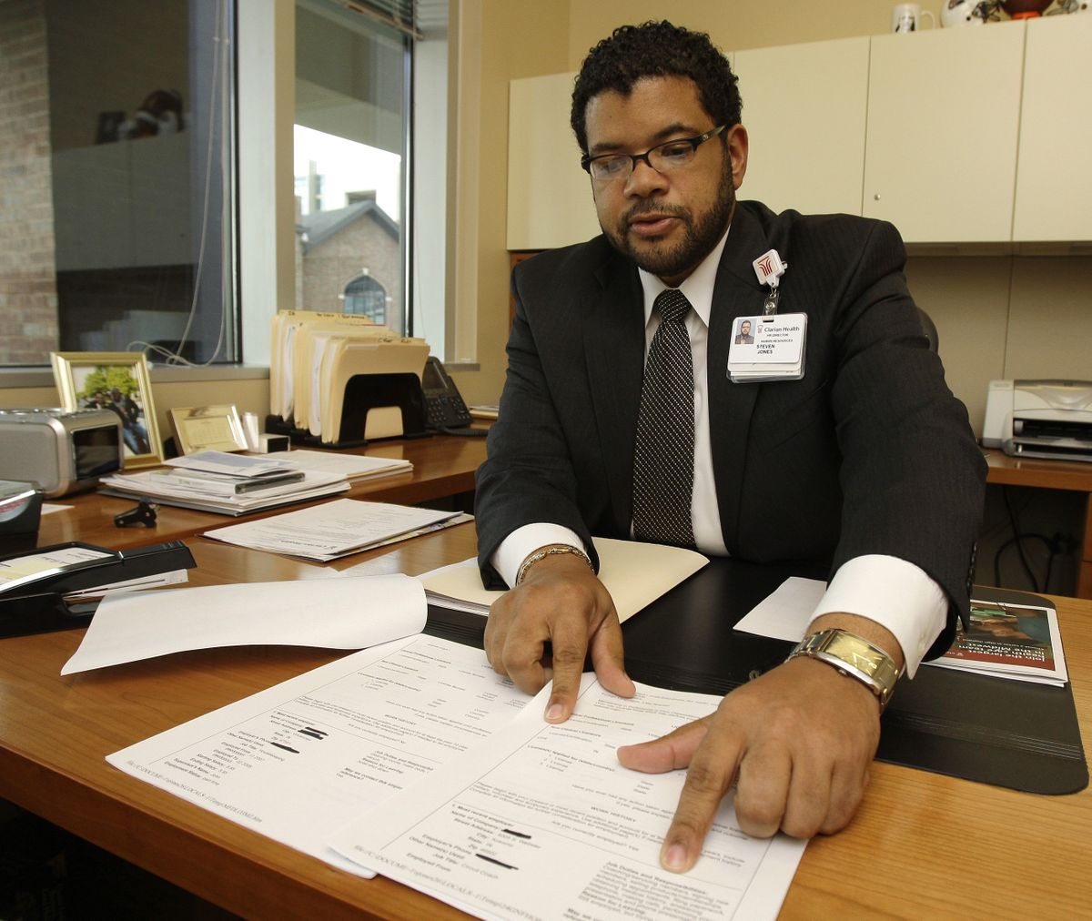 Recruiter Steve Jones reads through an application in his office at Clarian Health’s Methodist Hospital in Indianapolis on Sept. 28. Jones is trying to fill 228 open “critical” jobs at Clarian, including nurses, pharmacists, MRI technicians and ultrasound technologists.  (Associated Press / The Spokesman-Review)
