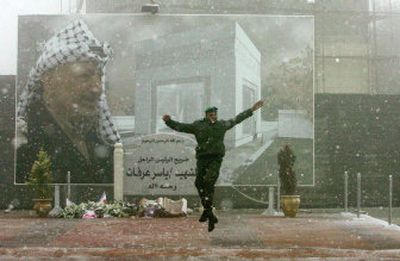 
A member of the security force guarding Palestinian President Mahmoud Abbas leaps as it snows in the West Bank town of Ramallah on Wednesday. 
 (Associated Press / The Spokesman-Review)