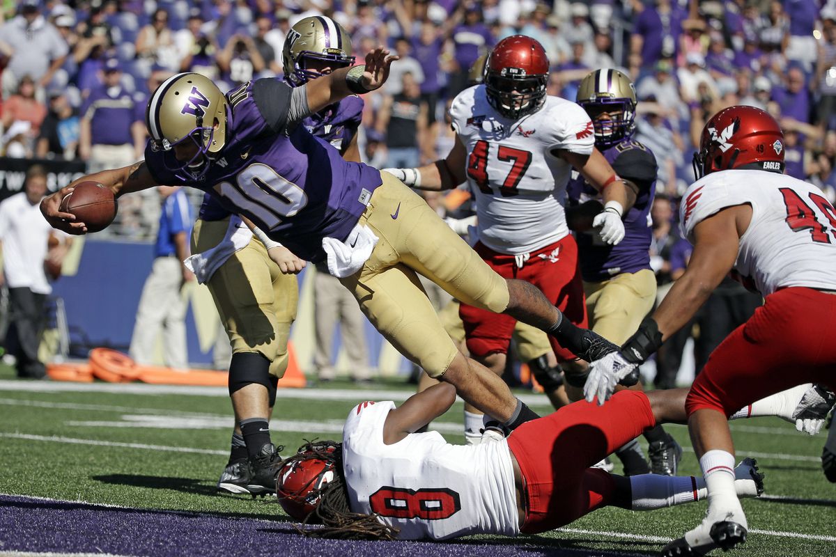 Washington quarterback Cyler Miles dives into the end zone for a 5-yard touchdown on the first play of the fourth quarter. (Associated Press)
