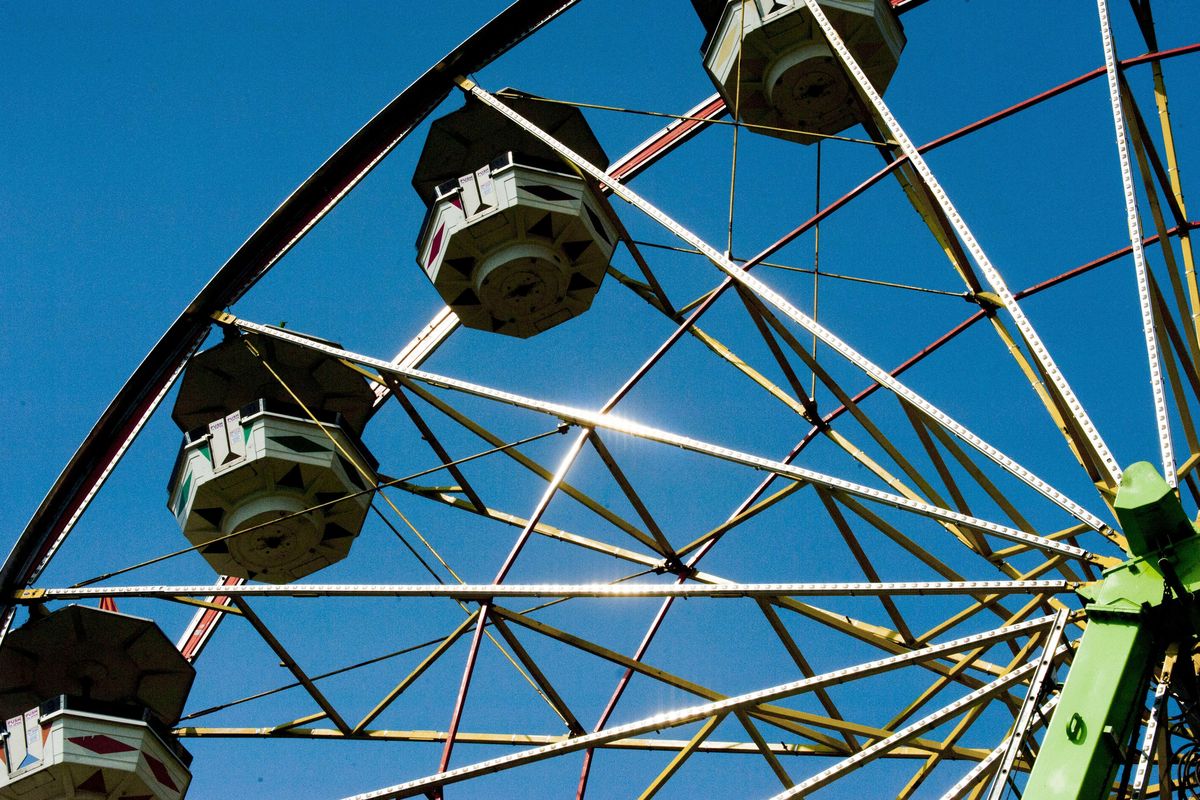 The Ferris wheel gleams in the sunshine at the Spokane County Interstate Fair. (Kathy Plonka / The Spokesman-Review)