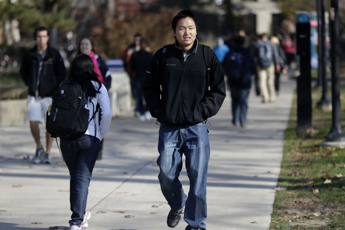 In this Friday, Nov. 9, 2012 photo, Kedao Wang, 21, of Shanghai, China, a senior at the University of Michigan walks on campus in Ann Arbor, Mich. Wang, one of about 6,400 overseas students at the University of Michigan, said his experience has been excellent but agrees growing numbers don�t solve the isolation problem. Virtually all Chinese students struggle at least somewhat to fit in, due to language and cultural barriers. New figures out Monday, Nov. 12, 2012 show international enrollment at U.S. colleges and universities grew nearly 6 percent last year, driven by a 23-percent increase from China, even as total enrollment was leveling out. But perhaps more revealing is where much of the growth is concentrated: big, public land-grant colleges, notably in the Midwest. (Paul Sancya / Associated Press)