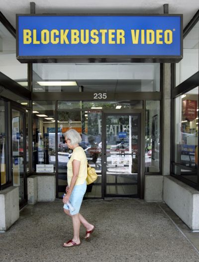 A pedestrian walks past a Blockbuster Video store in Boston in August. Blockbuster is planning to close as many as 960 stores by the end of next year. (File Associated Press / The Spokesman-Review)