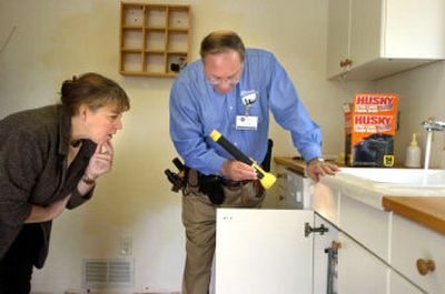 
Arthur Lazerow, president of Alban Home Inspection Service in Frederick, Md., points out problems with the sink to homeowner Vickie Lewis. Like many recent buyers, she purchased her house from sellers who would not accept offers requiring pre-sale inspections. 
 (Washington Post / The Spokesman-Review)