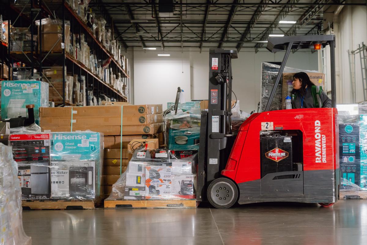 An employee unloads overstock items at ReturnPro on April 17 in Fort Worth, Texas. As retailers slow down orders for foreign goods because of tariffs, companies that recirculate overstocked or returned items may help fill the gap. (New York Times)