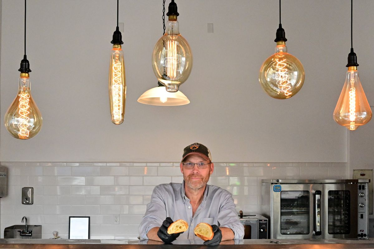 Clint Janson, manager and baker for Leaven Bakery & Patisserie, poses for with a croissant on Sept. 25 at Leaven Bakery & Patisserie, 7 S. Main St., in Deer Park.  (Tyler Tjomsland/The Spokesman-Review)