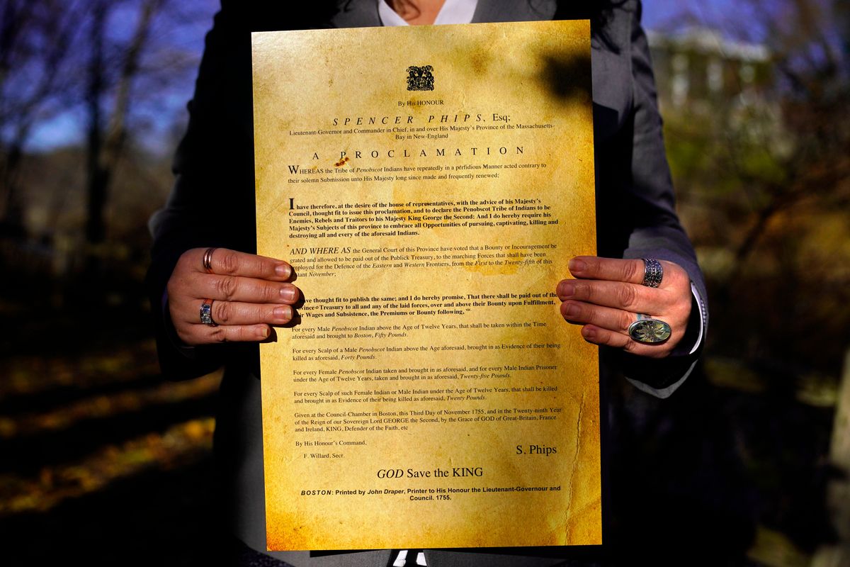 Dawn Neptune Adams holds a copy of the Phips Proclamation of 1755 on Nov. 23 in Bangor, Maine. Adams recently co-directed a film that focuses on the proclamation, one of the dozens of government-issued bounty proclamations that directed colonial settlers to hunt, scalp and kill Indigenous people for money.  (Robert F. Bukaty)