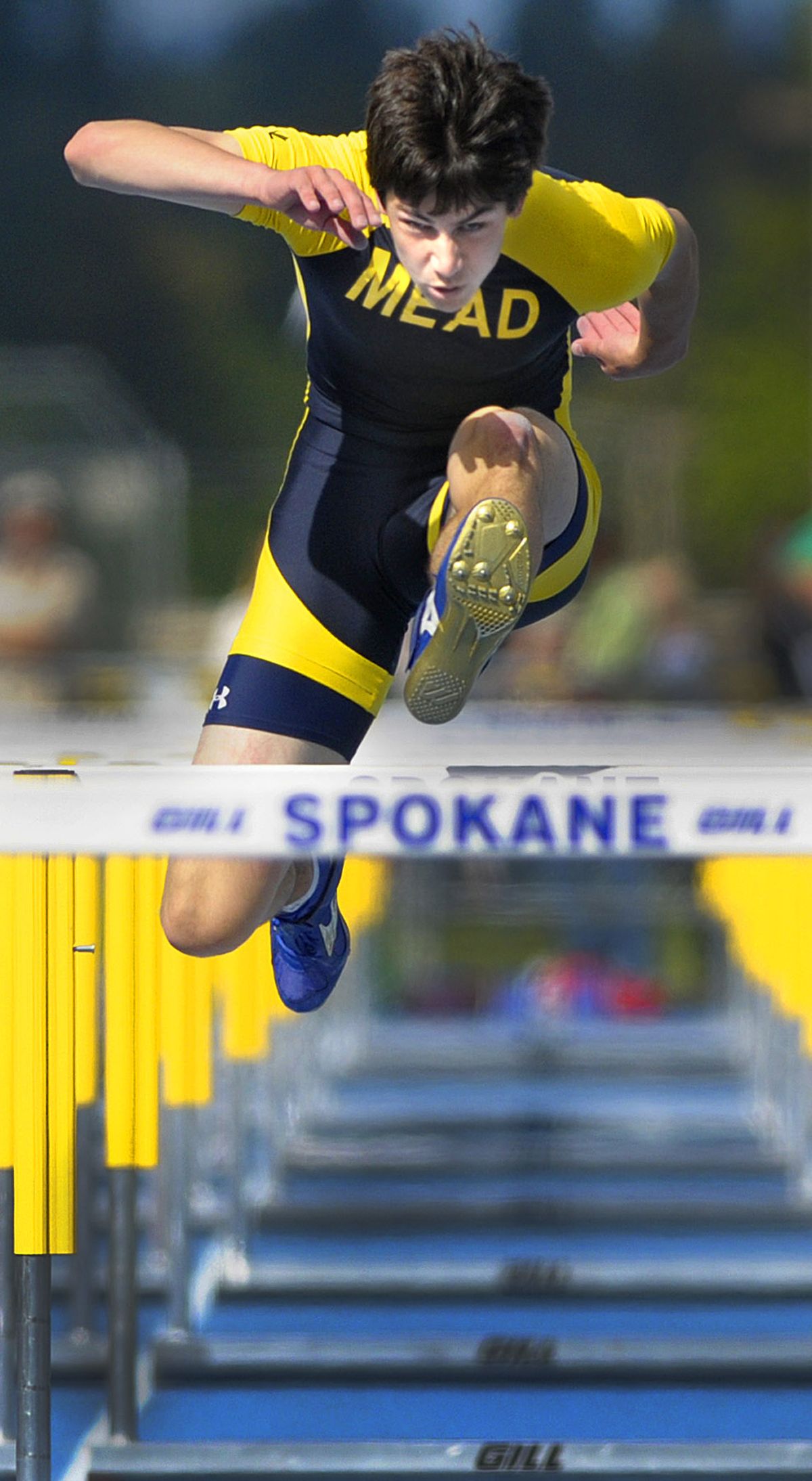 Casey Monahan of Mead runs a 14.8 to win the 110 hurdles at the District 8 track meet at Spokane Falls on Friday. (CHRISTOPHER ANDERSON / The Spokesman-Review)
