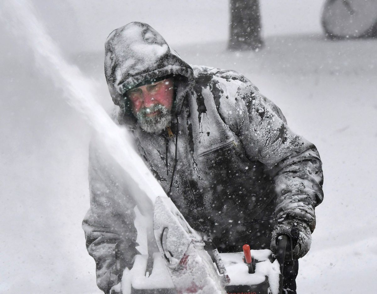 Dale McElwee clears his property of snow in North Attleboro, Mass.  (MARK STOCKWELL)