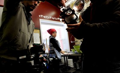 The Spokesman-Review Juanita Carmack, owner of The Salsa Factory, watches the production crew of MSNBC prepare for filming at her shop in Rathdrum on  April 1. (Kathy Plonka / The Spokesman-Review)