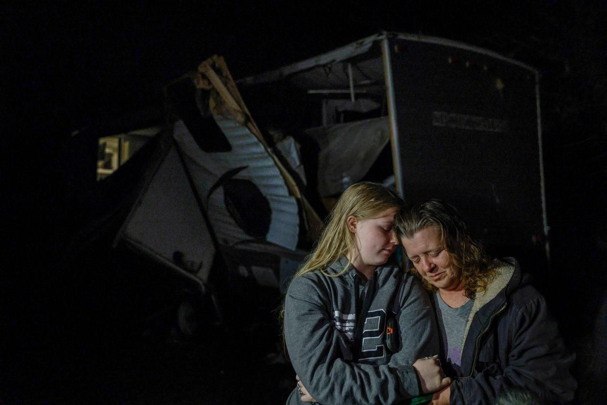 Brittaney Deaton, 17, left, comforts her mother Amber Zeleny, 53, while speaking with reporters after a severe storm passed in Johnson County near Burleson, Texas, Tuesday, April 5, 2022. The latest round of storms to pound the South prompted a flurry of tornado warnings at the start of what forecasters said could be two days of violent weather in the region. More than 55,000 homes and businesses were without power Tuesday morning from eastern Texas to southern Mississippi after storms.  (Elias Valverde II)