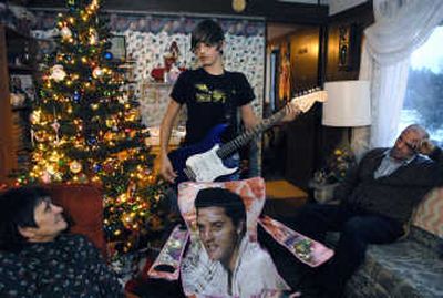 
Josh Kogler entertains his parents, Merlene and Henry, with his guitar in their donated trailer on Dec. 11 in Valley, Wash. A wildfire in 2006 destroyed the family's old trailer and most all of their belongings, including Josh's collection of Elvis memorabilia. 
 (Photos by Dan Pelle / The Spokesman-Review)