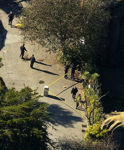 Police officers examine the tiger enclosure at the San Francisco Zoo on Wednesday after a Christmas Day tiger attack that left one person dead and two others injured. Associated Press photos
(Associated Press photos / The Spokesman-Review)