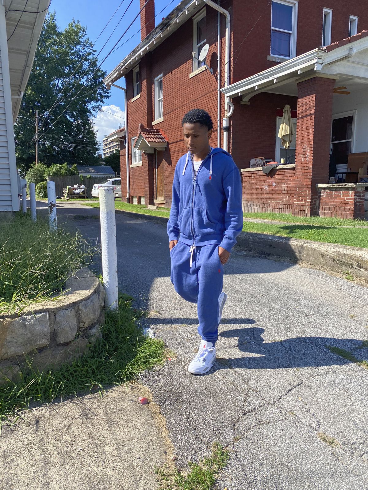 In this Sept. 9, 2021, photo X'Zane Watts walks out of the alley in Charleston, W.Va. where he was chased in 2017 at age 15 by undercover officers who followed him into his home and pointed a gun at his head. Police said that he appeared to fit the description of a burglary suspect. The family settled with the city for an undisclosed sum.  (Colleen Long)