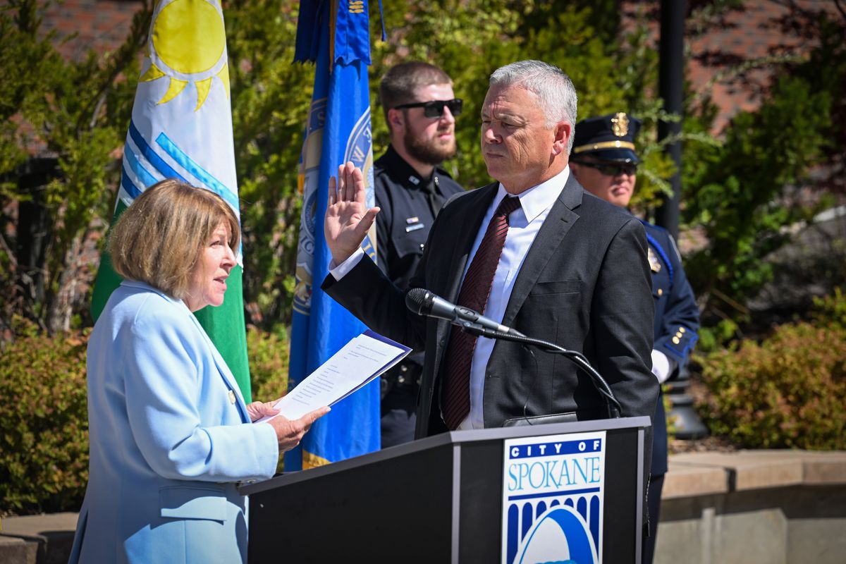 New Spokane Police Chief Kevin Hall, right, is sworn in by Spokane Mayor Lisa Brown in front of a small audience Monday, Aug. 26, 2024 in the Tribal Gathering Place next to Spokane City Hall. Hall is moving from the Tucson, Arizona area to take the position.  (Jesse Tinsley/The Spokesman-Review)