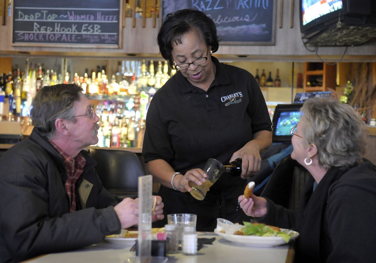 Cynthia Bracey-Coleman serves lunch to customers Rod and Jackie Haight at Charley’s Grill & Spirits on Jan. 15.  (CHRISTOPHER ANDERSON / The Spokesman-Review)